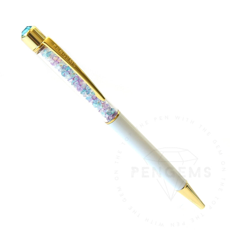 A white crystal pen with gold hardware and a chamber of pastel blue, purple, and pink crystal chatons.