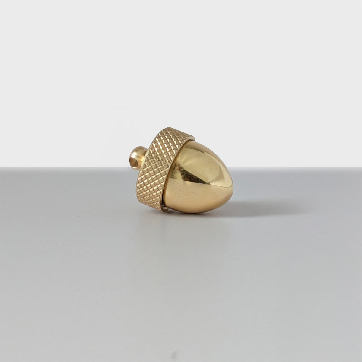 Brass acorn locket with a twist-off top