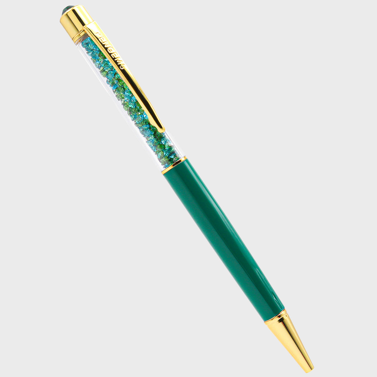 Wicked crystal pen with an emerald teal barrel, gold hardware, and a chamber packed with teal and green crystal chatons.