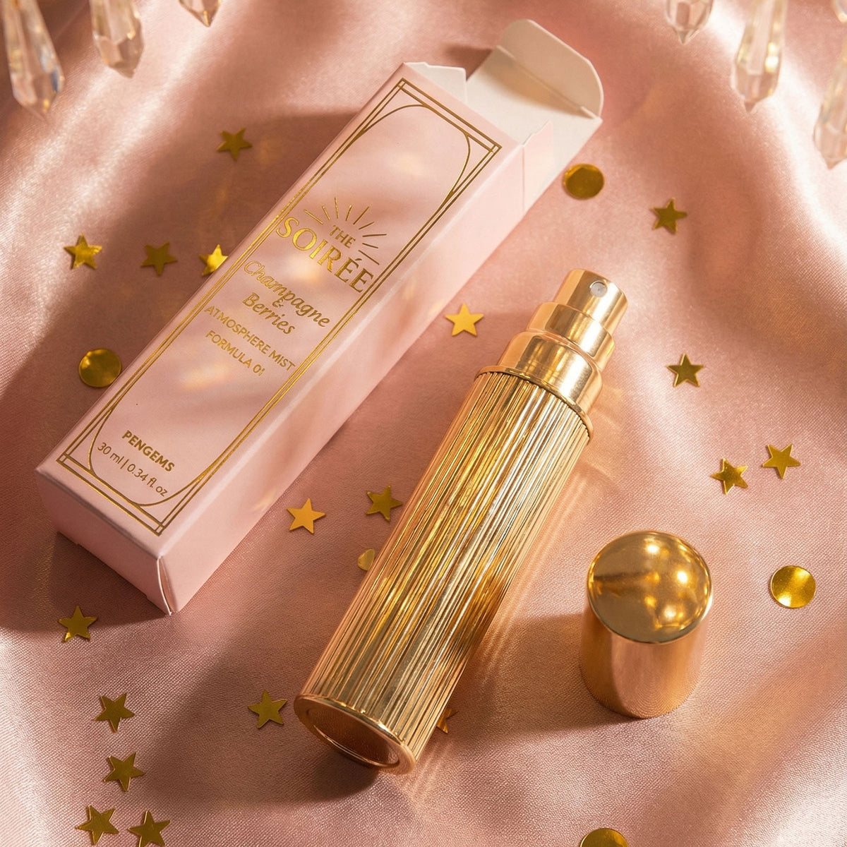 Gold cosmetic bottle and packaging on a pink fabric background with gold stars